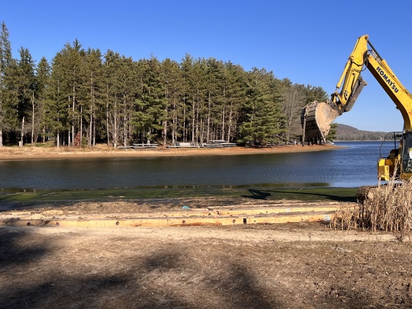 Backhoe near the waters edge of the cove